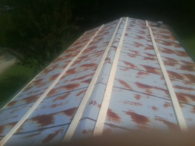 Rusted metal roof panels with new wood purlins before replacement — Storm Damage Roof Repair in Avilla by Roofing Brothers